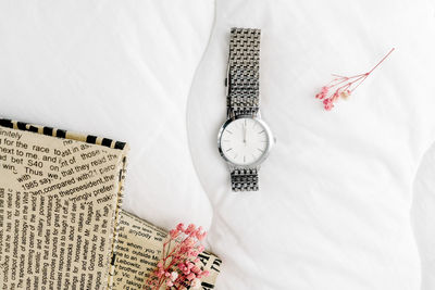 High angle view of clock on bed