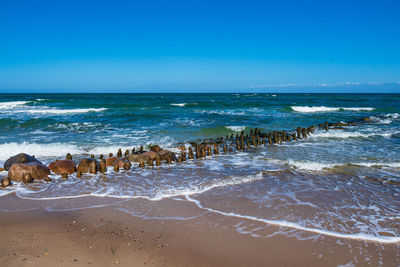 Scenic view of beach against blue sky