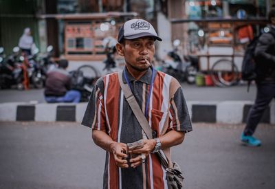Young man looking at city street