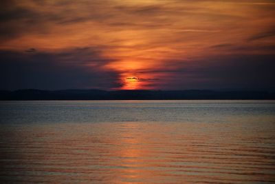 Scenic view of sea against orange sky