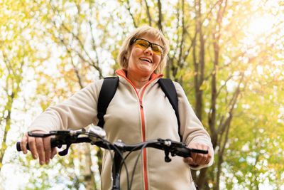 Portrait of smiling woman riding bicycle