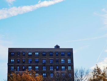 Low angle view of buildings against blue sky