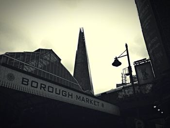 Low angle view of information sign against sky