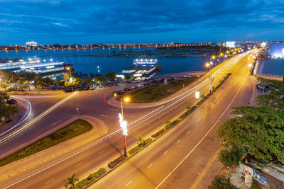 High angle view of light trails on highway in city at night