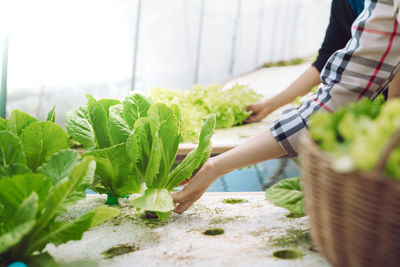 Midsection of woman having food outdoors