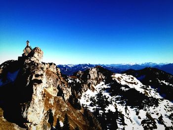 Scenic view of mountains against clear blue sky