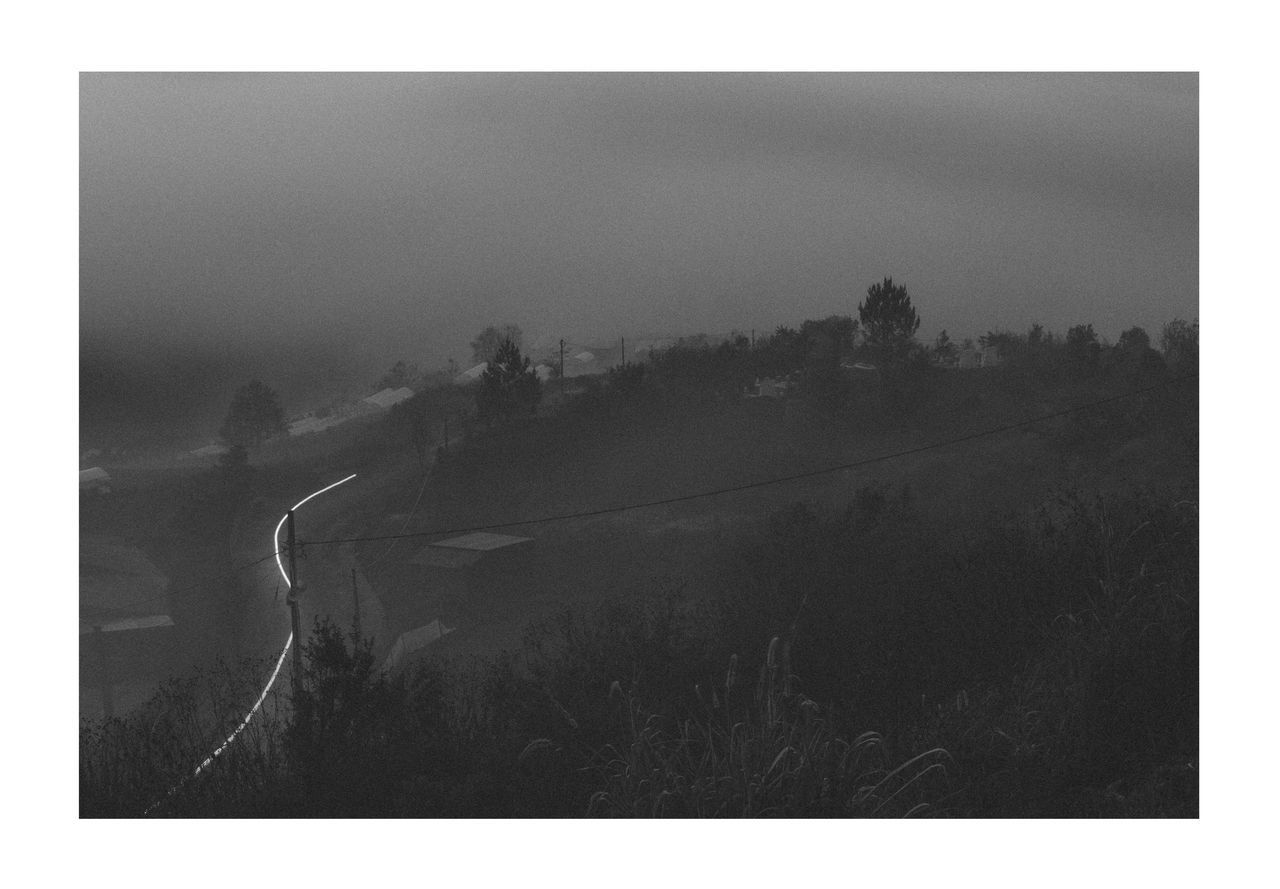SCENIC VIEW OF FOG OVER FIELD AGAINST SKY