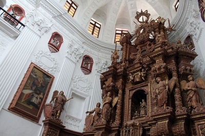 Low angle view of sculptures on ceiling of building