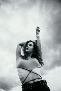 Low angle view of woman standing against sky