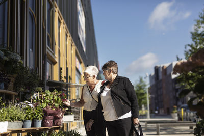 Senior women looking at flowers for sale