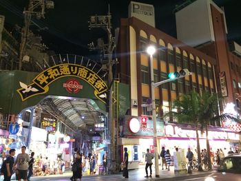 People in illuminated city at night