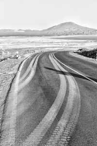 Road by landscape against clear sky