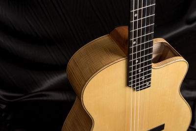 High angle view of guitar on bed