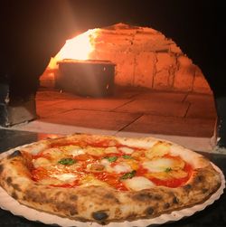 Close-up of pizza served on table in restaurant