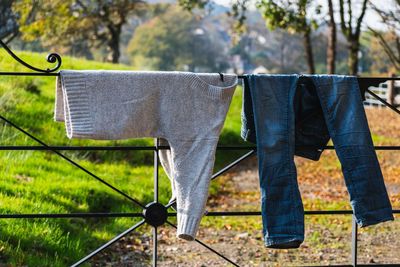 Clothes drying on clothesline on field