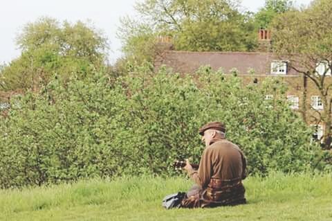 grass, field, tree, grassy, growth, plant, sitting, green color, day, nature, outdoors, landscape, abandoned, relaxation, men, rural scene, agriculture, built structure