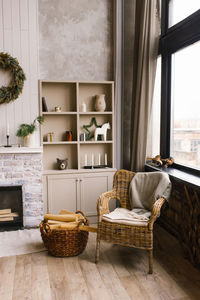 Scandinavian interior of a country house. a living room with a fireplace and a wicker armchair