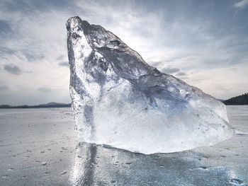 Ice covered the lake. big cracks in tin ice floe and reflection of sun rays.