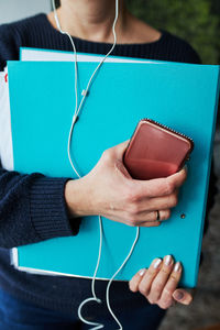 Midsection of woman using mobile phone