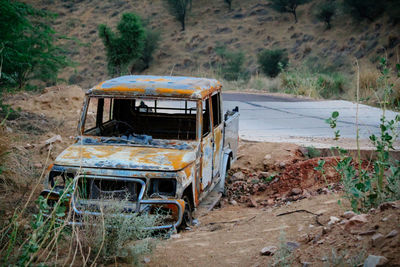 Abandoned car on field