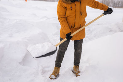 Low section of man skiing on snow