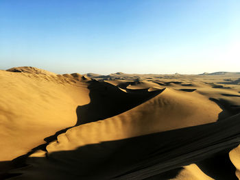 Scenic view of desert against clear sky