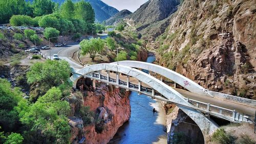 High angle view of bridge over river against mountains