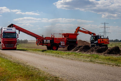 The harvest of potatoes, loaded with a crane in a potato cleaning machine 