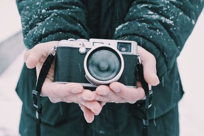 Midsection of man photographing with camera