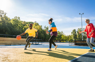 Full length of woman exercising on soccer field