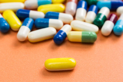 Close-up of medicines over colored background