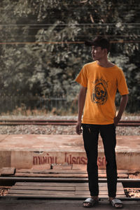 Young man standing on railroad station platform