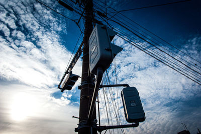 Low angle view of telephone pole against sky