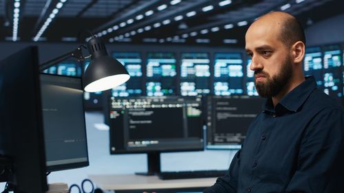 Side view of man standing in office