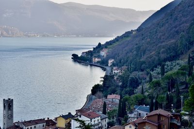 High angle view of townscape by sea against sky