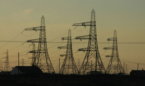 Electricity pylon against sky at sunset