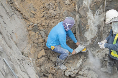 Man working on rock at construction site