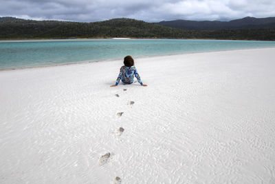 Rear view of boy on beach