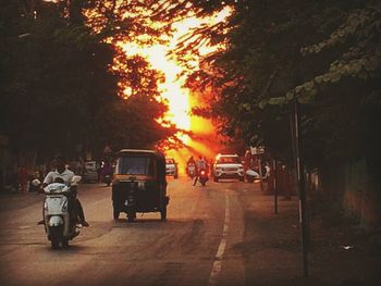 Rear view of people on road at night