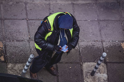 High angle view of man working on footpath