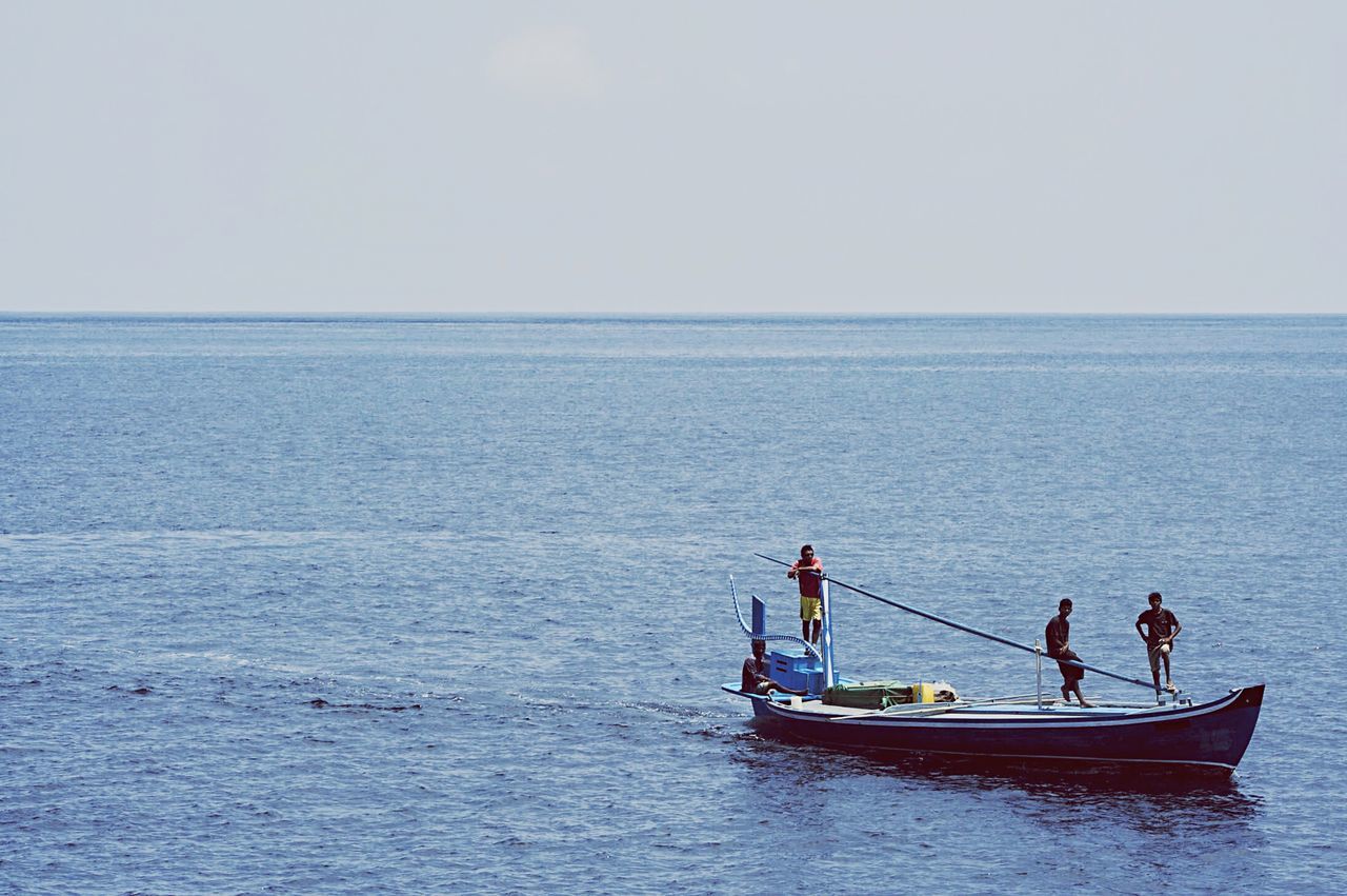 water, sea, transportation, nautical vessel, mode of transport, horizon over water, boat, men, waterfront, lifestyles, leisure activity, sailing, clear sky, copy space, scenics, tranquil scene, tranquility, nature, beauty in nature