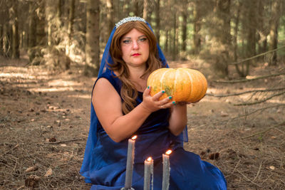 Rear view of woman holding pumpkin