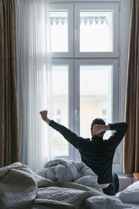 Young woman lying on bed at home