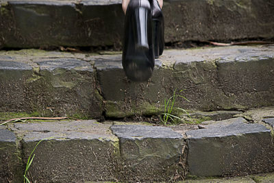 Low section of woman standing on tiled floor