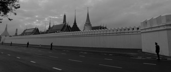 View of bridge in front of river against cloudy sky