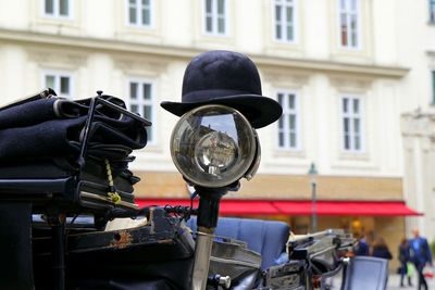 The black hat on a spotlight of a carriage. vienna, austria.