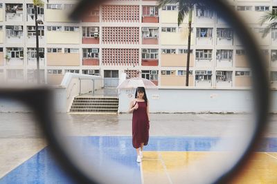 Woman standing by window