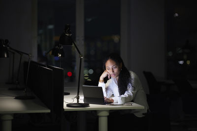 Woman working late in office