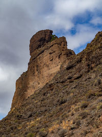 Low angle view of rock formation against sky