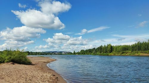 Sandy river bank against the blue sky on a sunny day